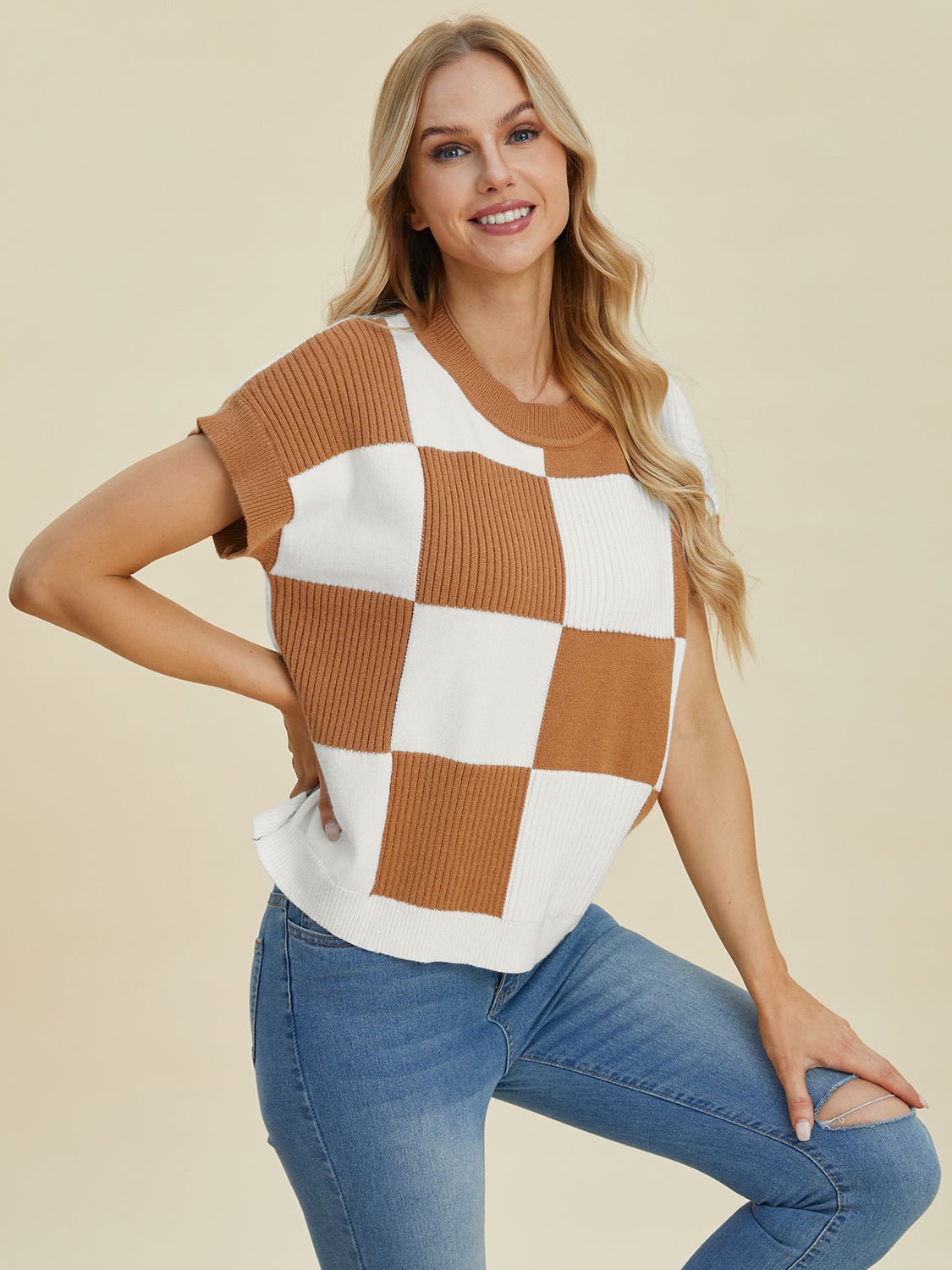 Woman wearing a checkered round neck short sleeve sweater in brown and white, featuring a basic style with slightly stretchy material.