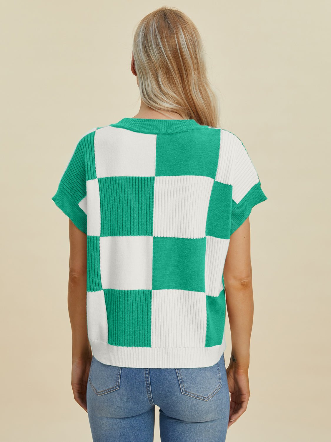 Woman wearing a green and white checkered round neck short sleeve sweater with slightly stretchy fabric, back view.