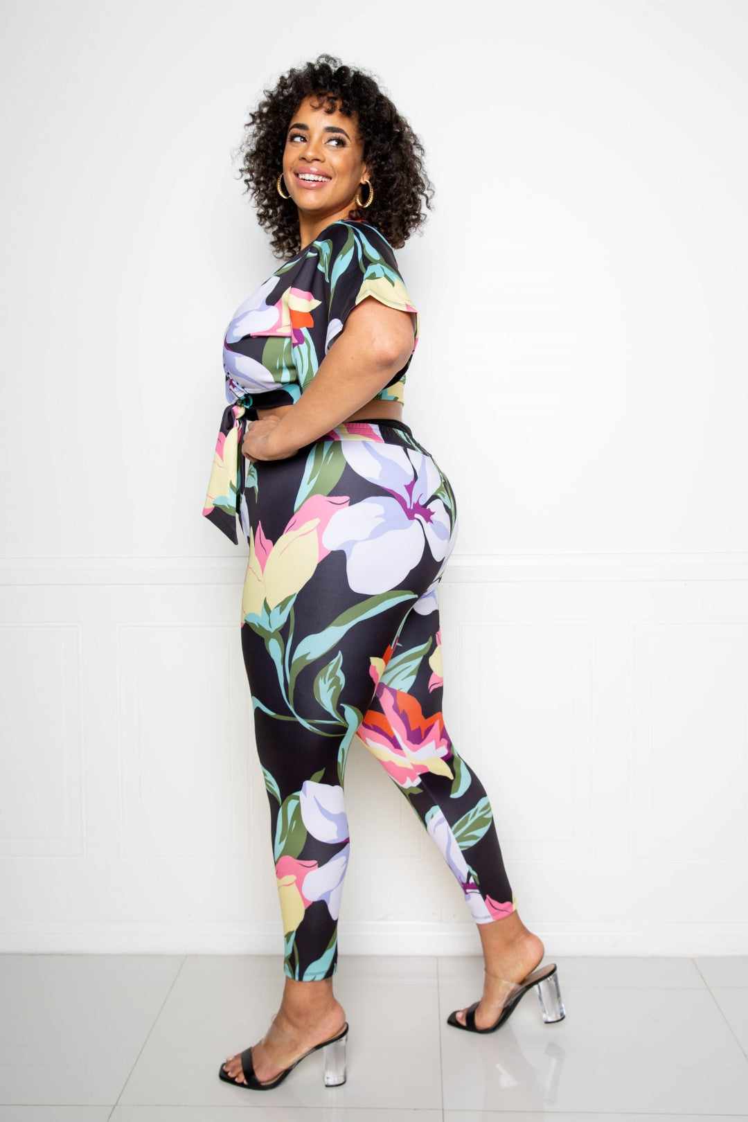 Woman wearing Flower Jogger & Top Set in multi-black floral print, showcasing plus size fashion in 1XL, 2XL, 3XL.