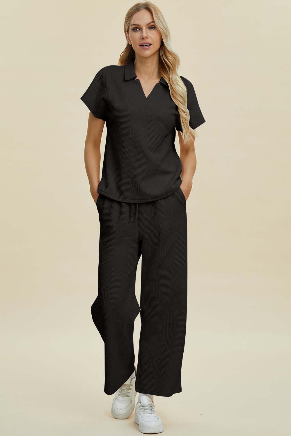 Full size collared neck short sleeve top and pants set in black, featuring a basic style with slight stretch, made of polyester and elastane.