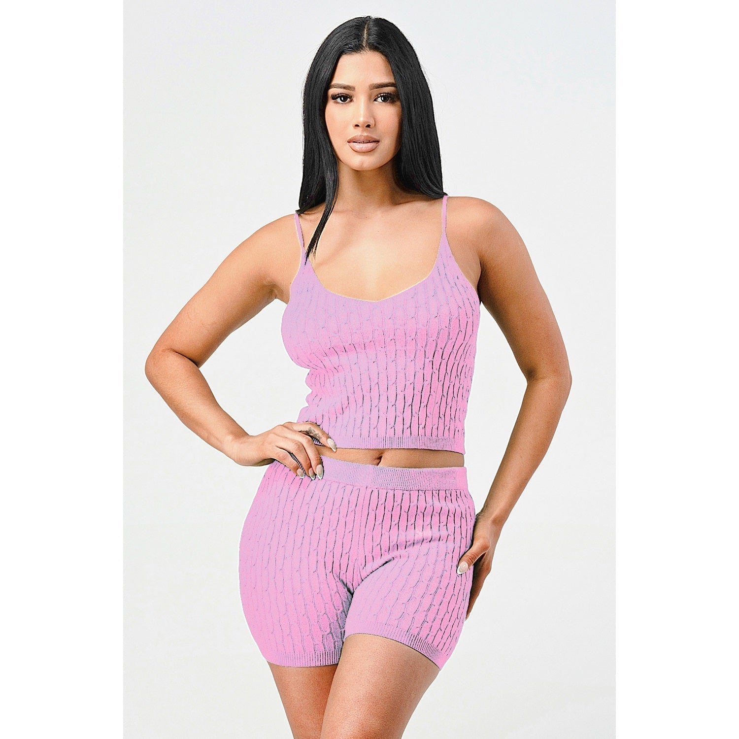 Woman wearing pink cami knit top and shorts set made of 50% viscose, 25% nylon, and 25% polyester.