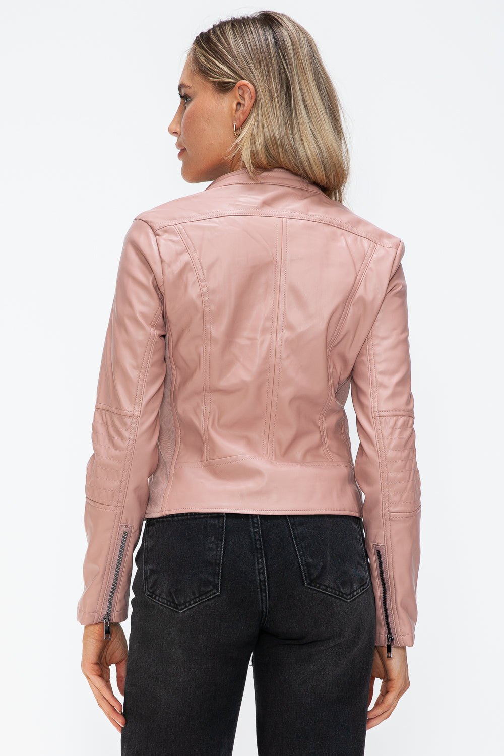 Woman wearing mauve faux leather zip-up jacket with drawstring hood, seen from the back. Stylish, pocketed design with normal thickness.