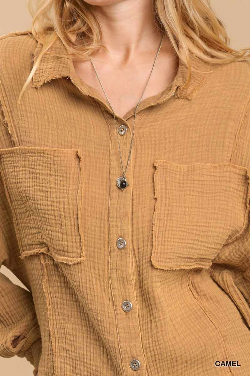 Mineral wash camel button down top with high low hem and chest pockets, made from polyester and spandex blend.