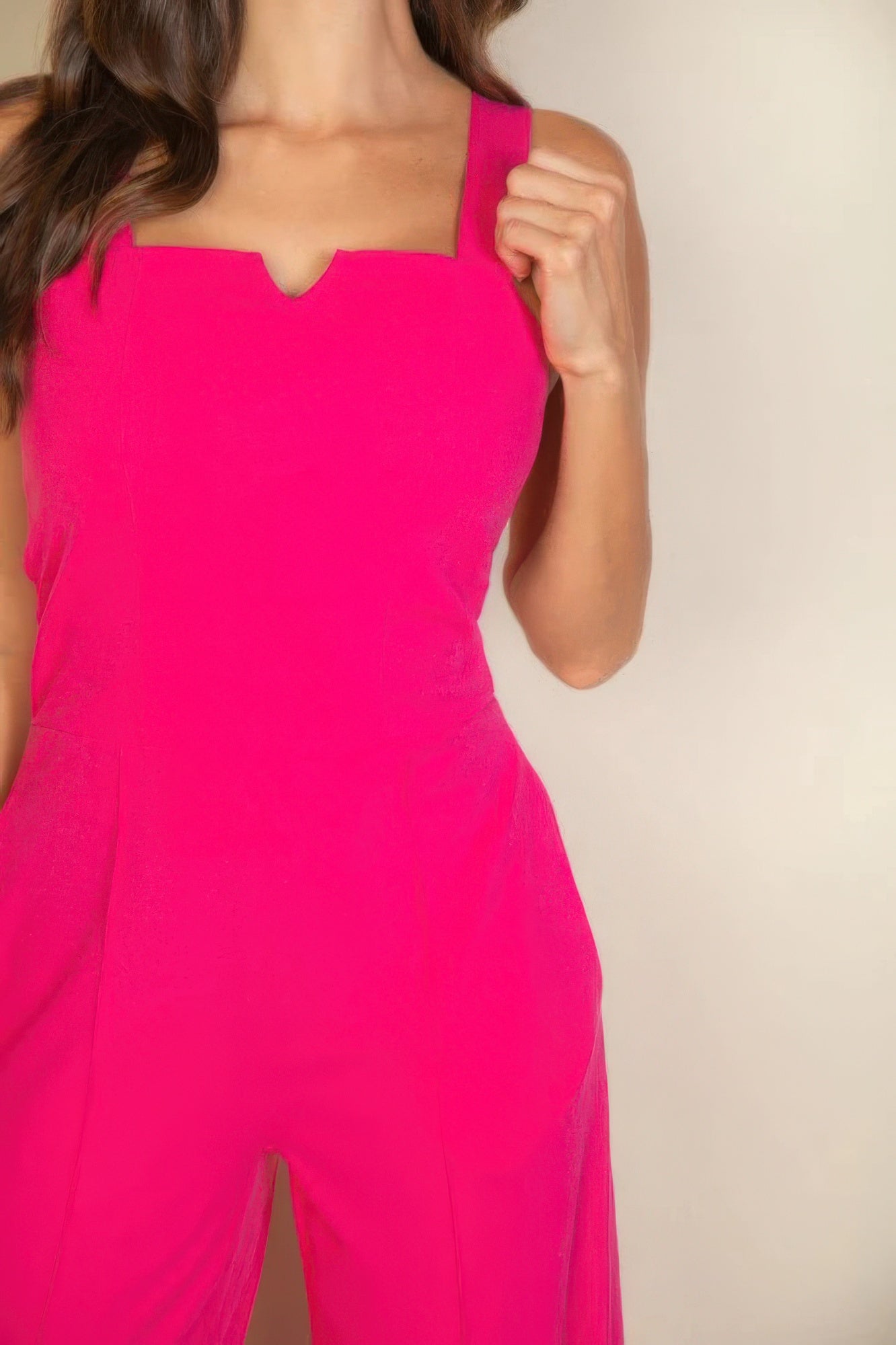 Pink notched neck cami jumpsuit with flattering fit and modern design worn by model.