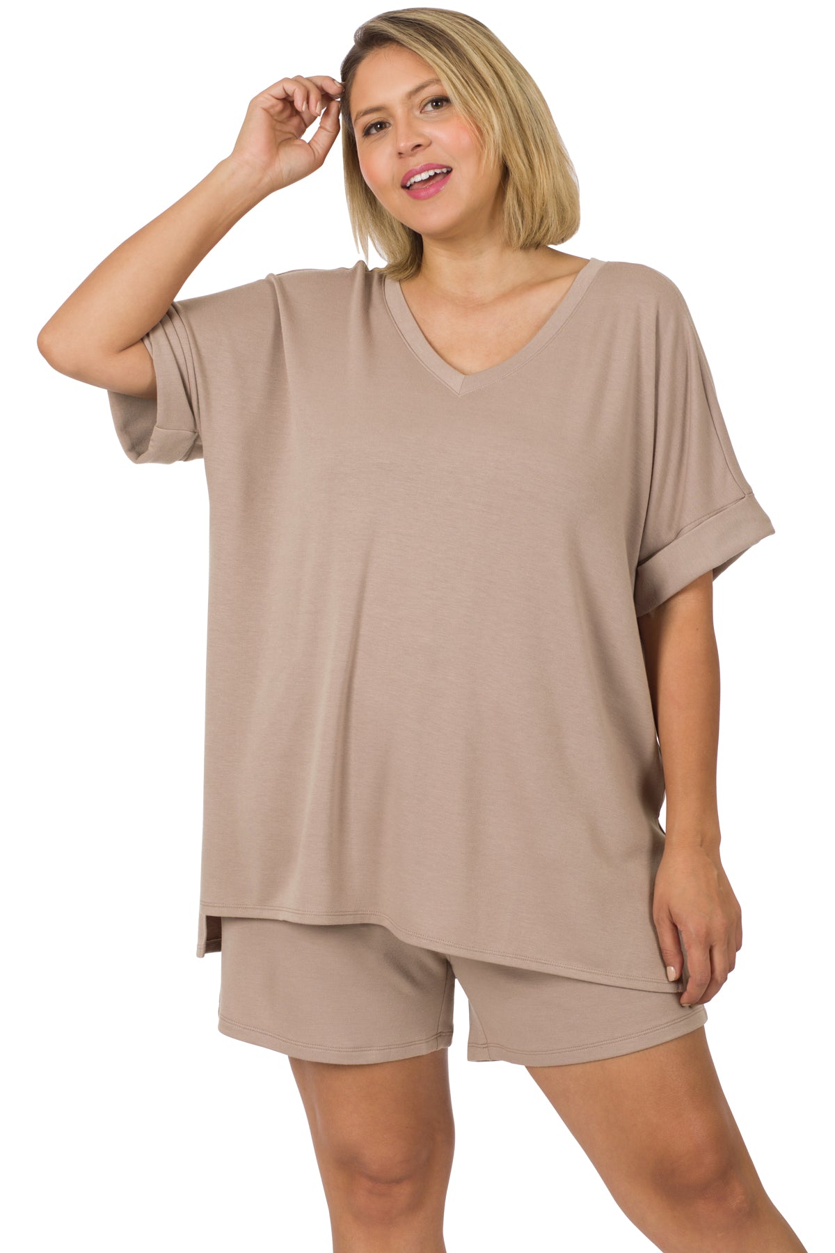 Plus-size woman wearing a taupe brushed microfiber top and biker shorts set with a relaxed fit, front pocket, and hi-low hem.