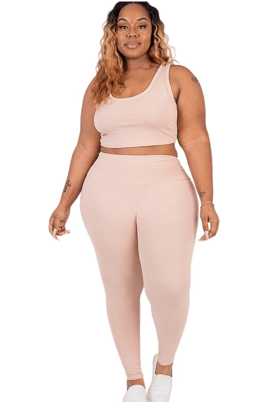 Plus size model wearing ribbed crop top and leggings set in soft, comfortable fabric, perfect for loungewear or sports activities.