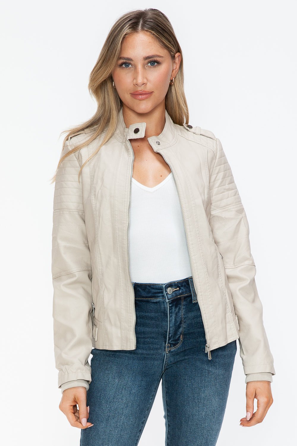 Woman wearing sand PU leather biker jacket with side zip pockets, featuring a basic style in normal thickness, unlined body.