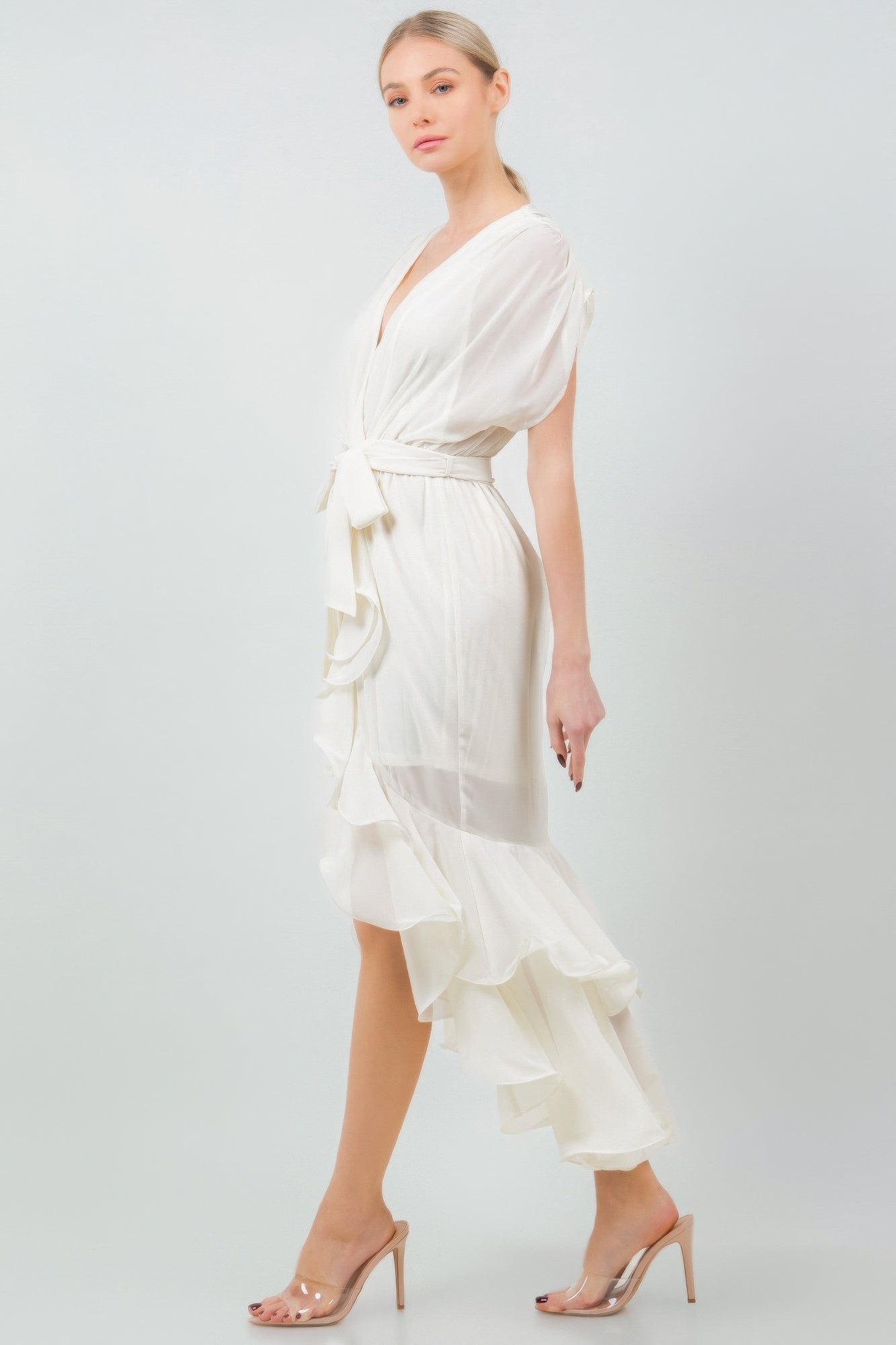 White ruffle midi dress with tie waist, modeled on woman, showcasing elegant and feminine style, perfect for stylish outings.