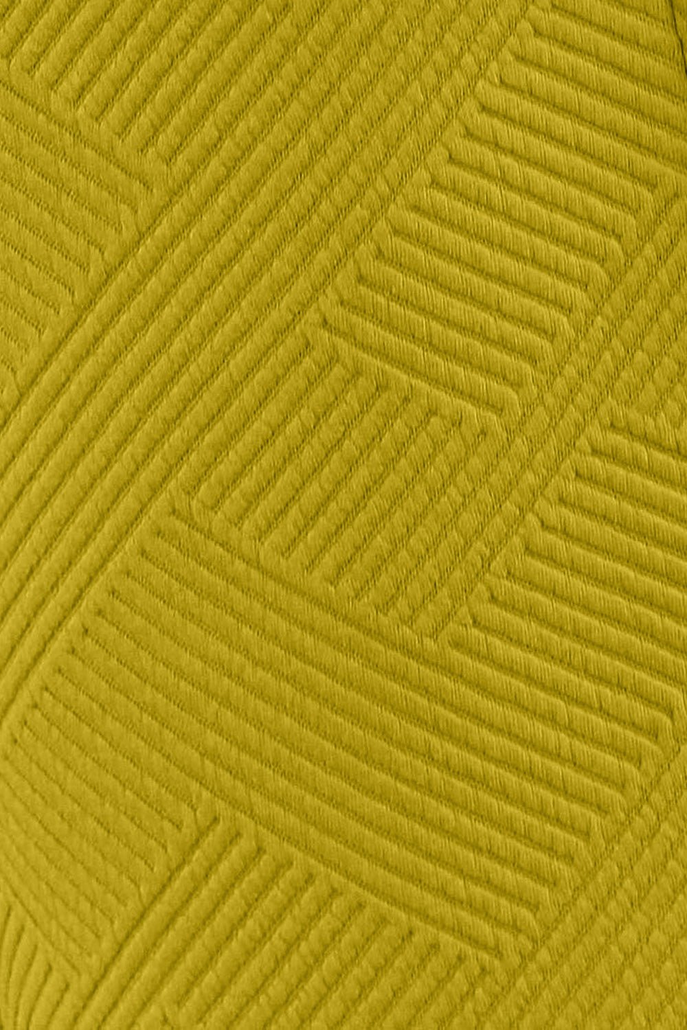 Textured fabric close-up in mustard yellow with geometric pattern