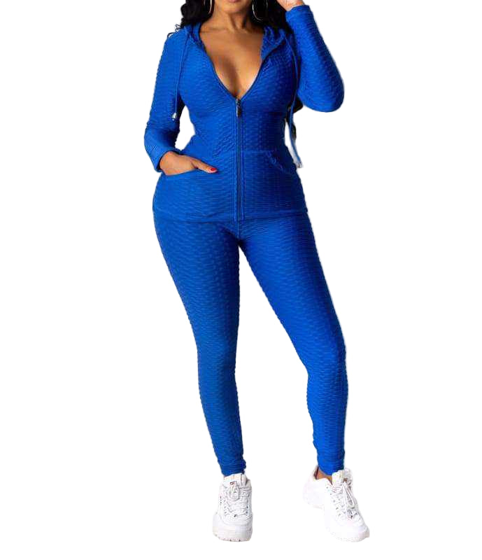 Woman wearing blue Baddie With Body Brazil Two-Piece Set with hooded jacket and pants, made of polyester and spandex.