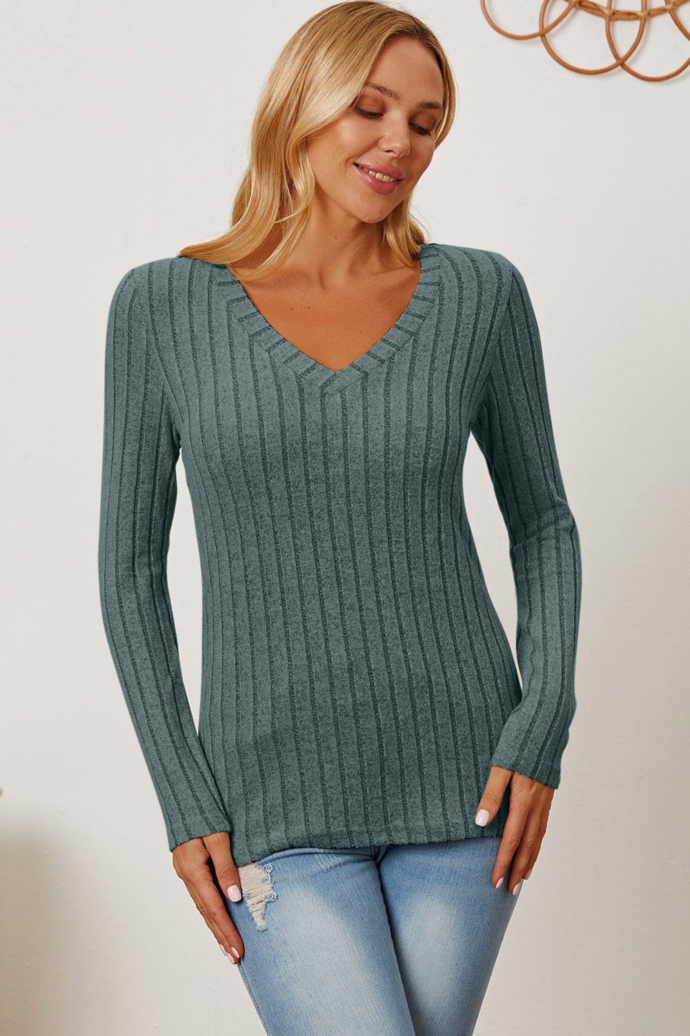 Woman wearing a Basic Bae ribbed V-neck long sleeve T-shirt in teal, paired with light blue jeans.
