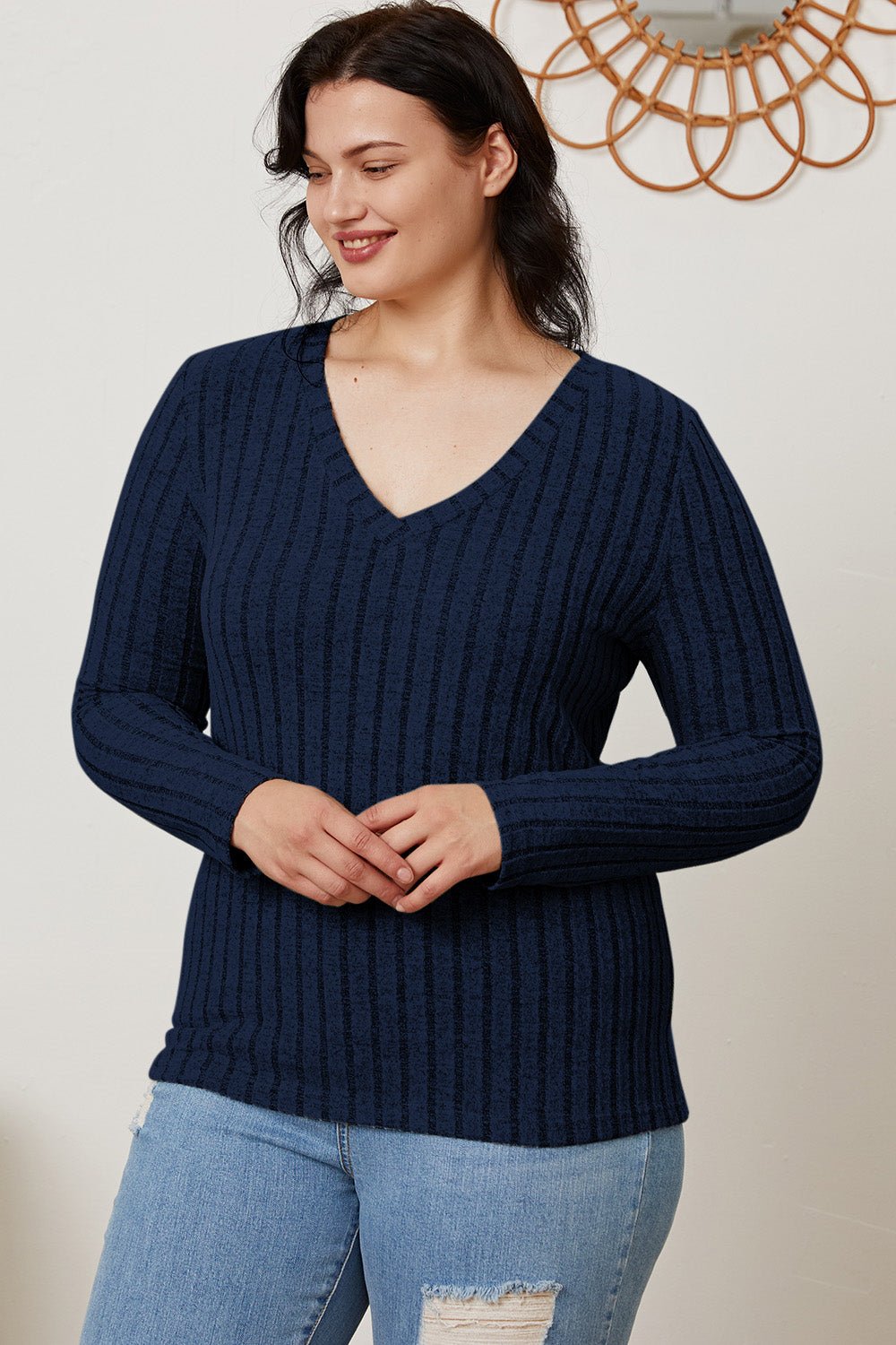 Woman wearing Basic Bae Ribbed V-Neck Long Sleeve T-Shirt in navy, styled with jeans; comfortable and slightly stretchy material.