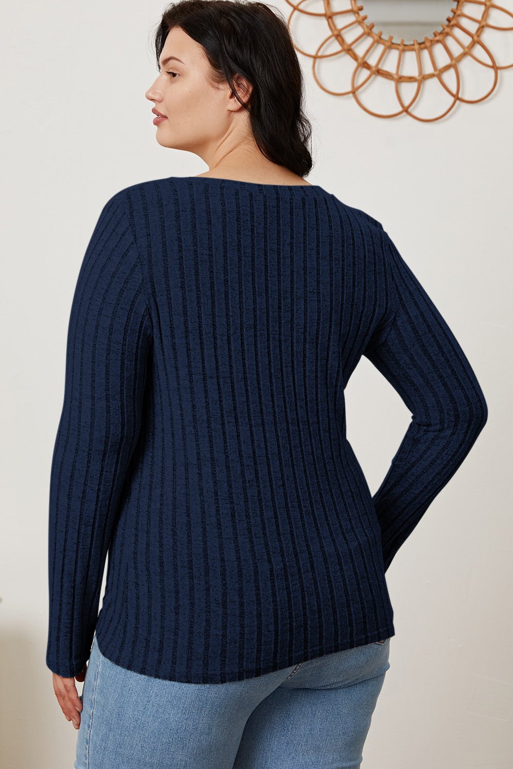 Woman in Basic Bae full-size ribbed V-neck long sleeve T-shirt, back view, showcasing slightly stretchy polyester blend fabric.