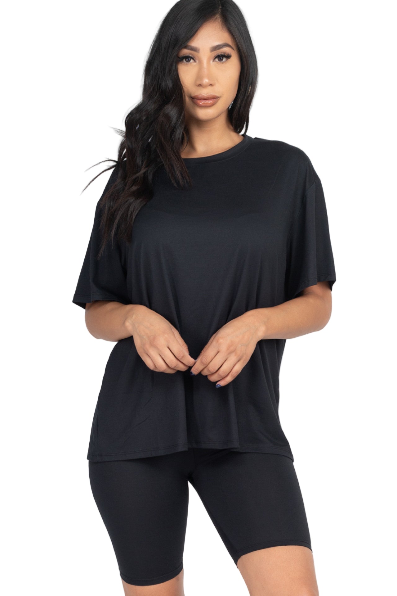 Woman wearing black loose fit top and biker shorts set, soft lightweight jersey, perfect for casual or workout.