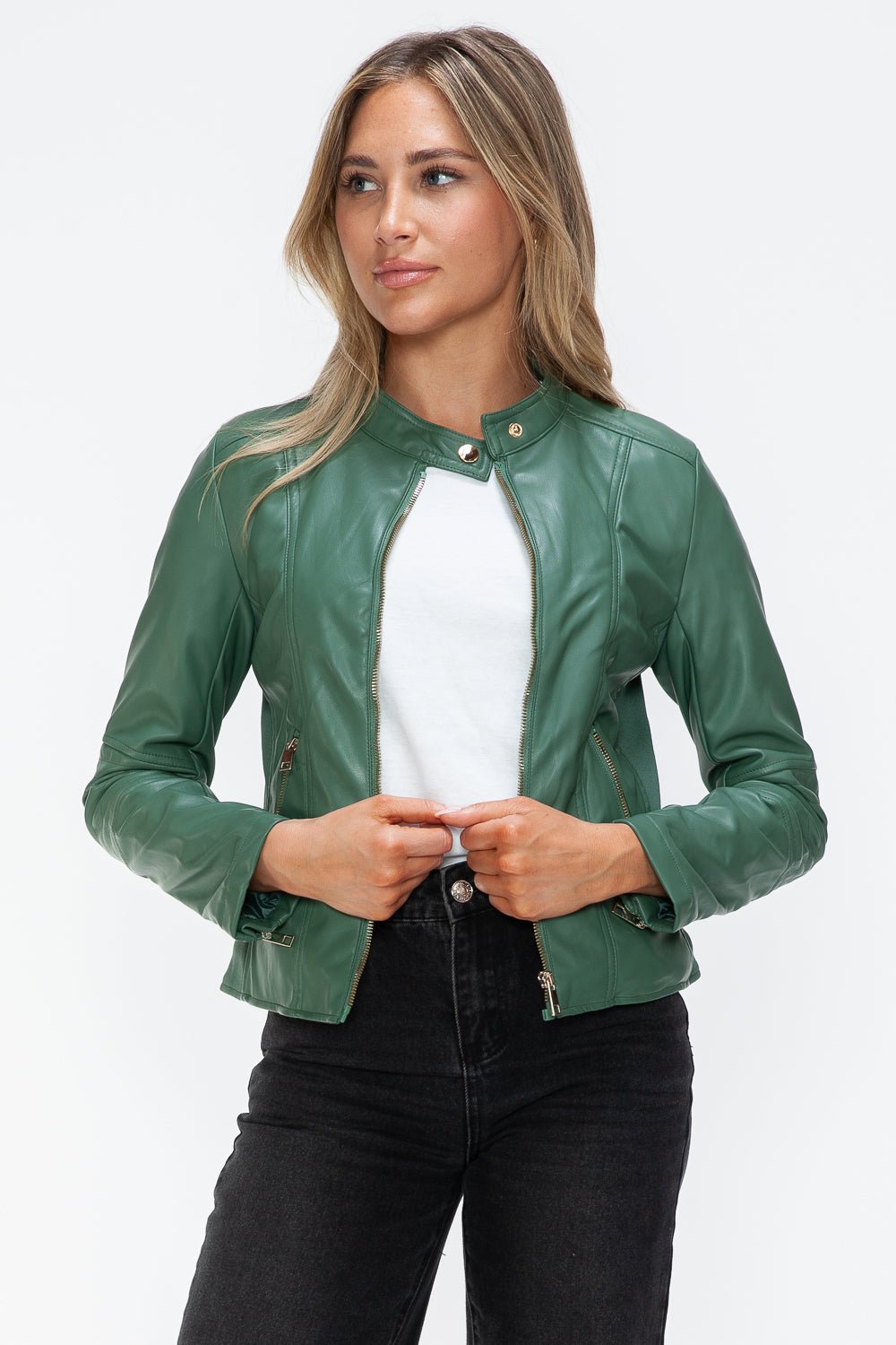 Woman wearing a green faux leather jacket with a zip-up front, showing a basic style and pocket detail.
