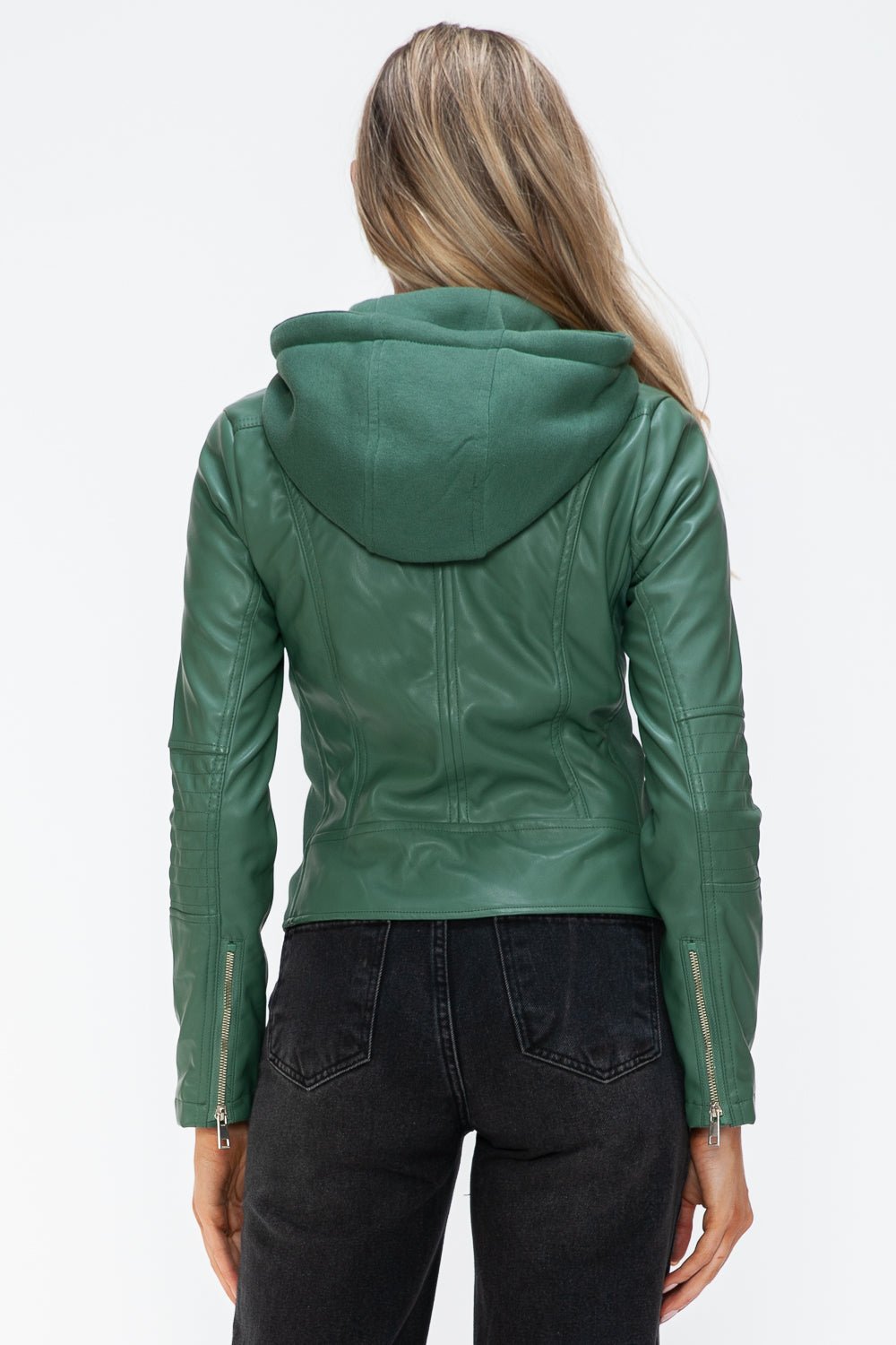 Woman wearing a green faux leather zip-up jacket with a drawstring hood and zipper cuffs, shown from the back.