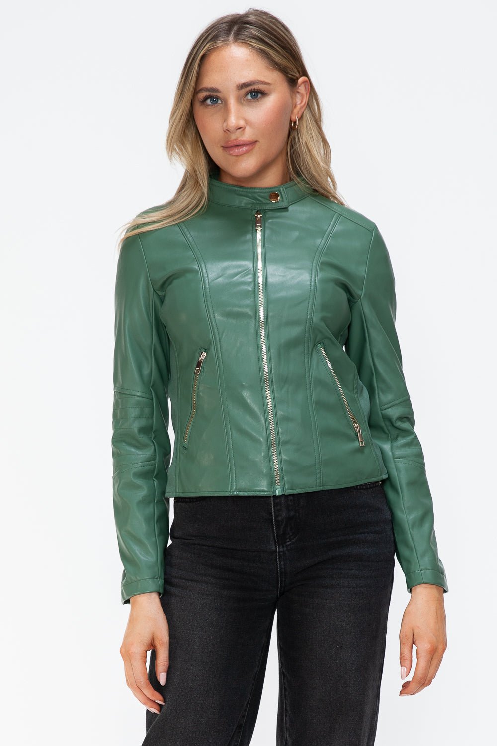 Woman wearing a green faux leather zip-up jacket with pockets and drawstring hood, showcasing basic style and normal thickness.