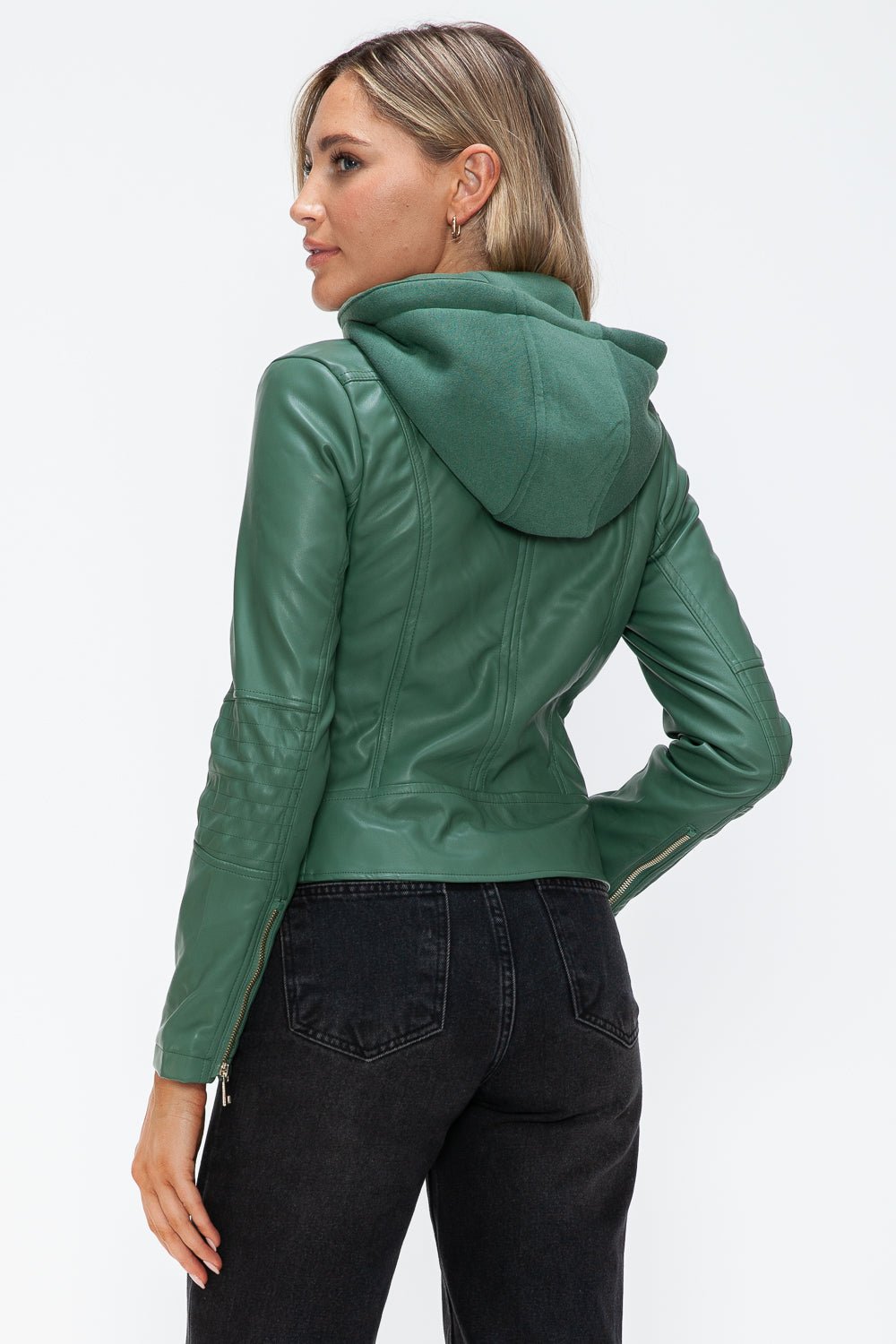 Woman wearing green faux leather zip-up drawstring hooded jacket with pocketed design, showing back view.