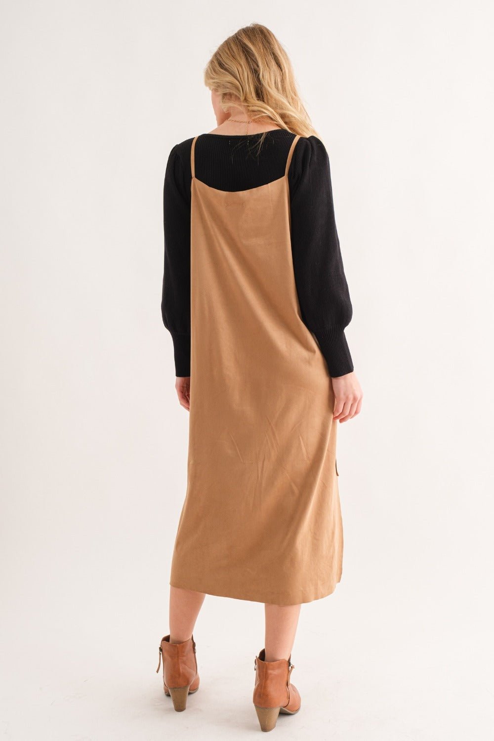 Woman wearing faux suede slit cami midi dress in tan, back view showing high-low design and slight stretchiness.