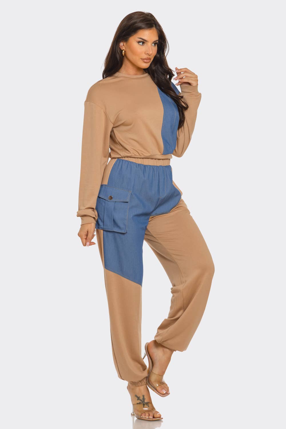 Woman wearing French Terry color block denim detail top and pants set with side pockets and elastic waistband.