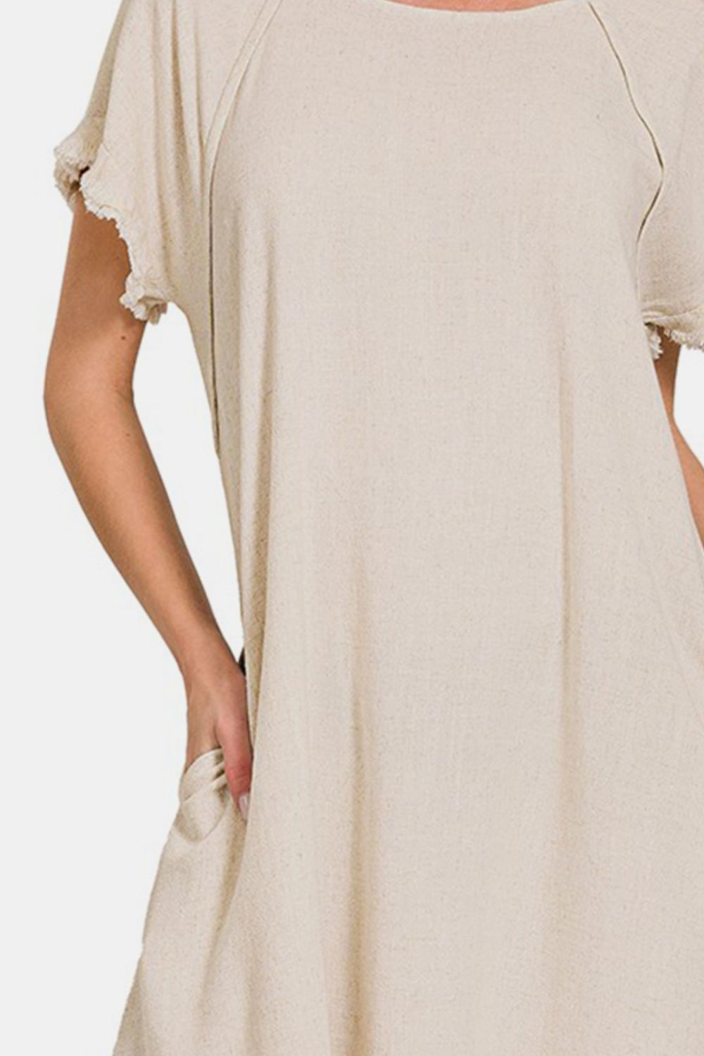 Beige fringe edge high-low flowy dress with pockets made of 87% rayon and 13% linen.