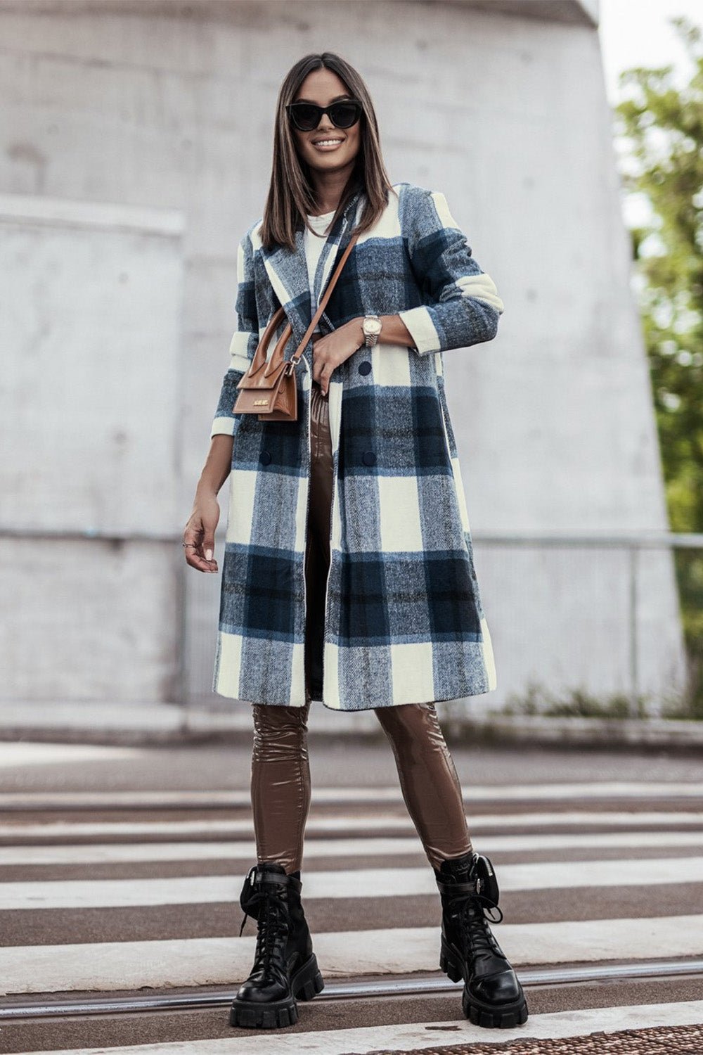 Woman wearing a stylish full-size plaid button-up lapel coat with pockets, made from 100% polyester, perfect for casual outings.