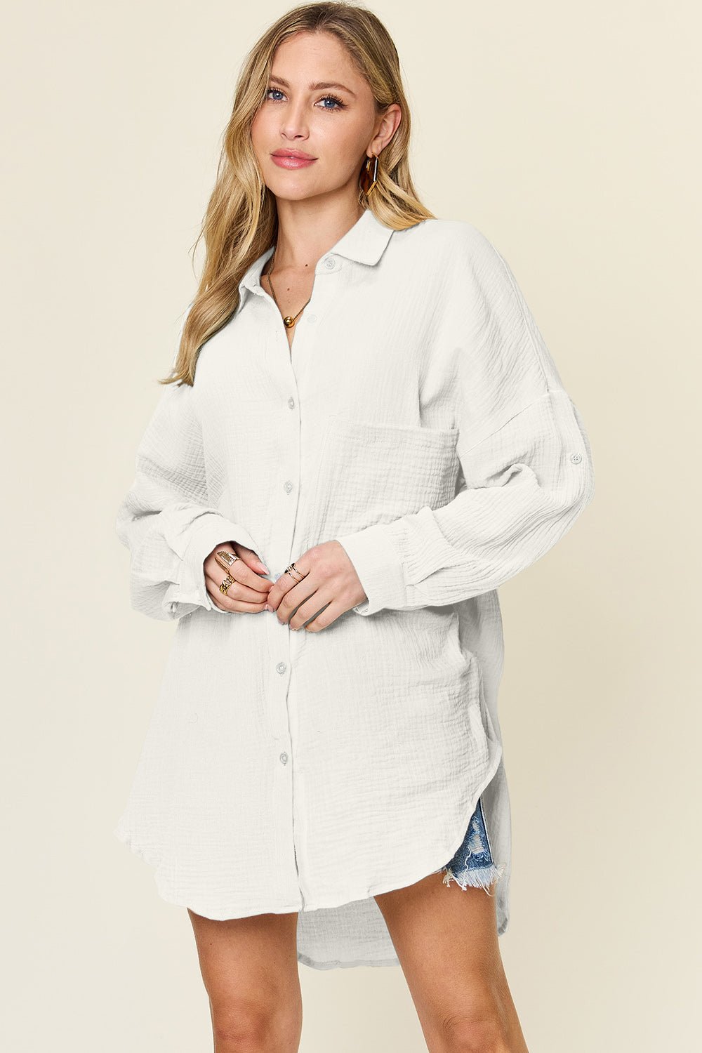 Woman wearing full-size white pocketed texture button-up shirt with slightly stretchy 100% cotton material, perfect for casual style.