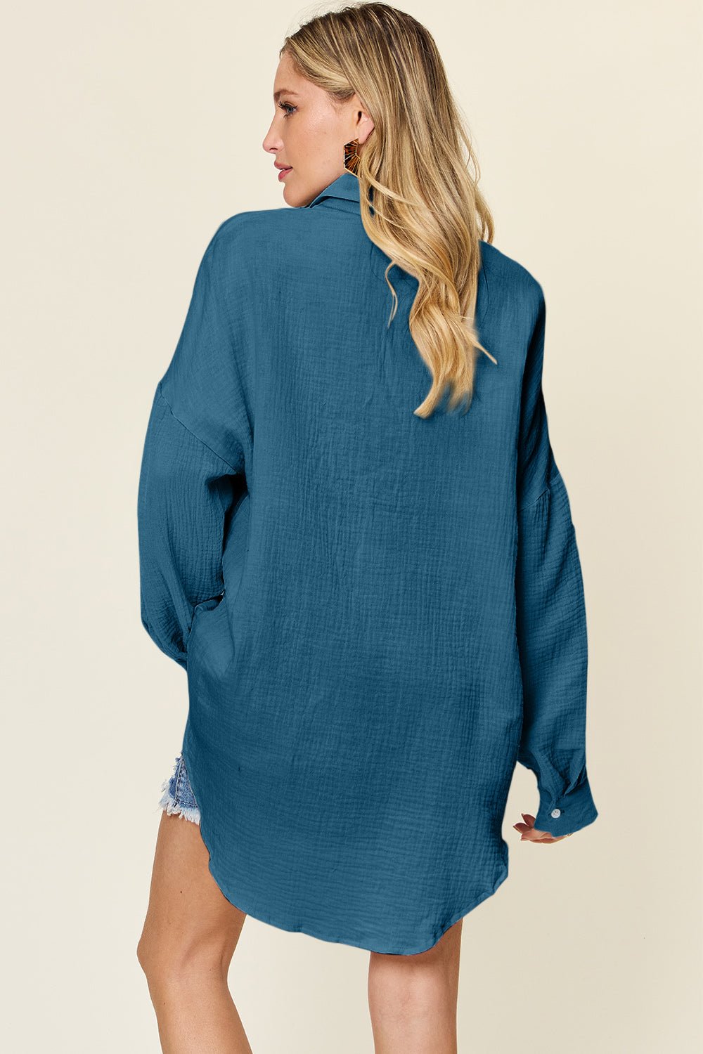 Full size pocketed texture button-up shirt in blue, 100% cotton, slightly stretchy, shown on model from back view.