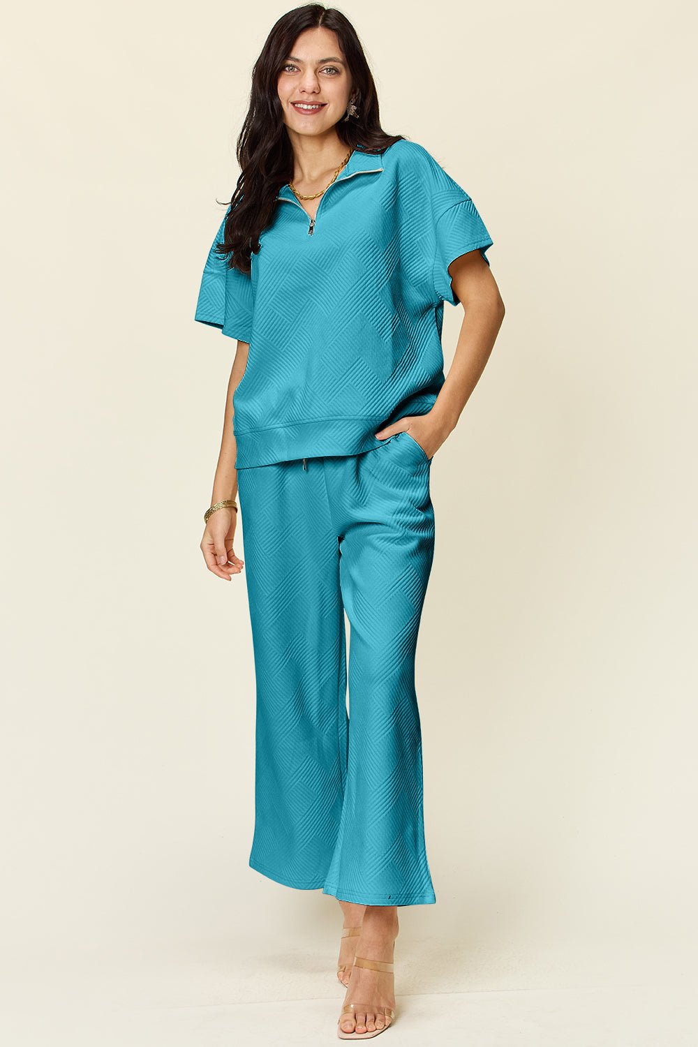 Full size turquoise half zip short sleeve top and pants set with pockets and drawstring, slightly stretchy polyester and spandex blend.