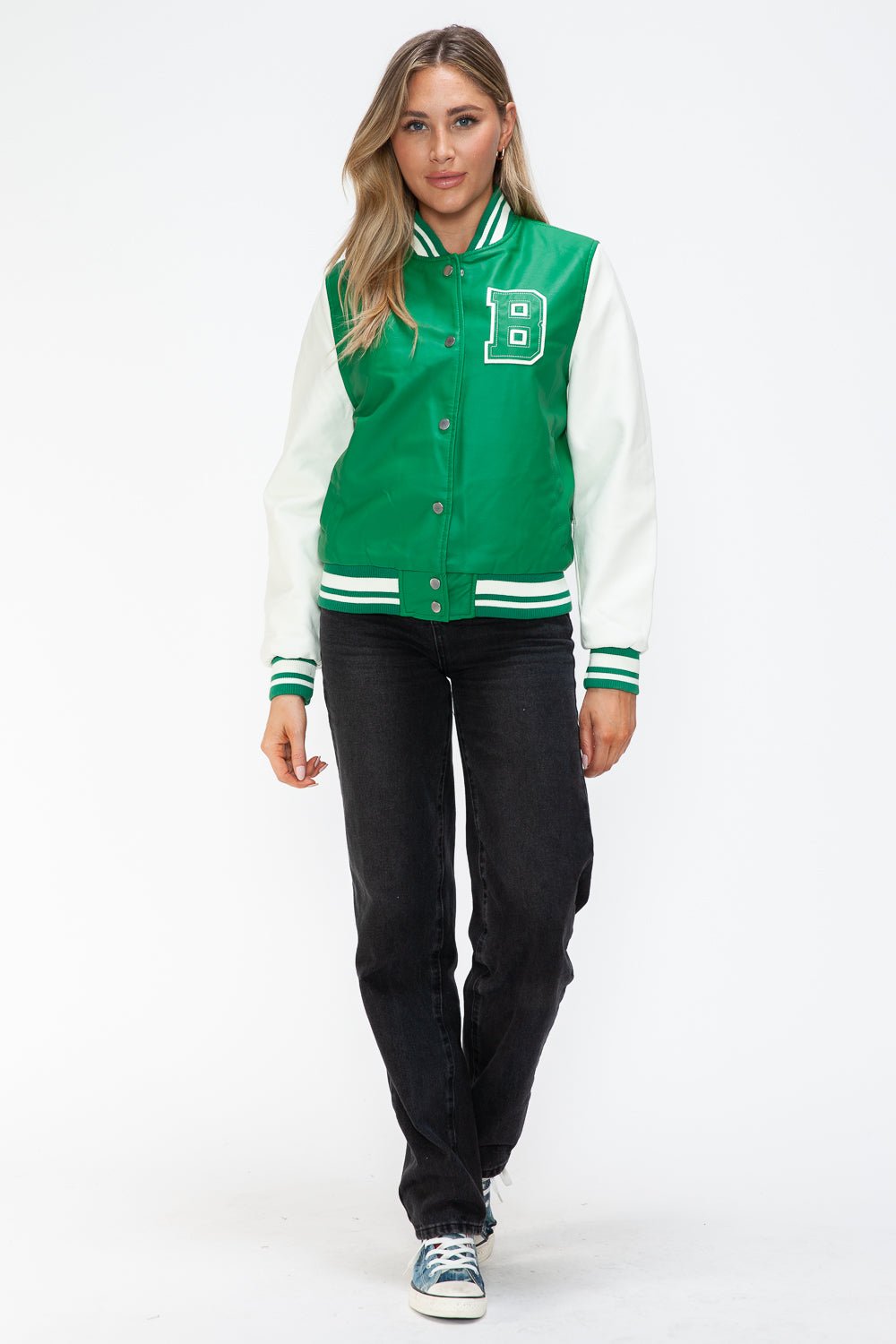 Green PU leather bomber jacket with contrast snap down and varsity design, worn by model. Perfect for casual style and layering.