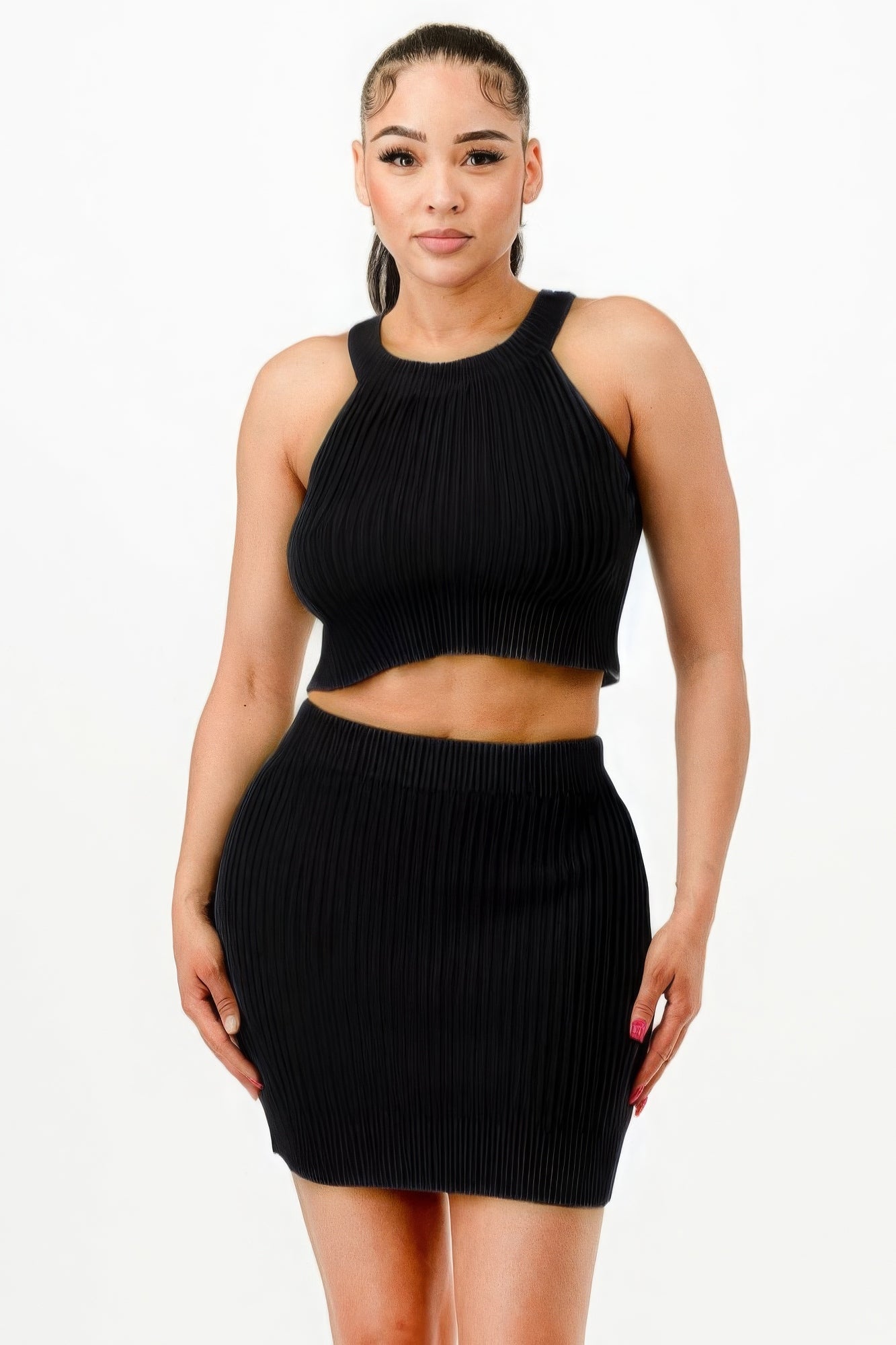 Woman wearing chic black halter neck tank top and bodycon mini skirt set, perfect for parties and casual-chic events.