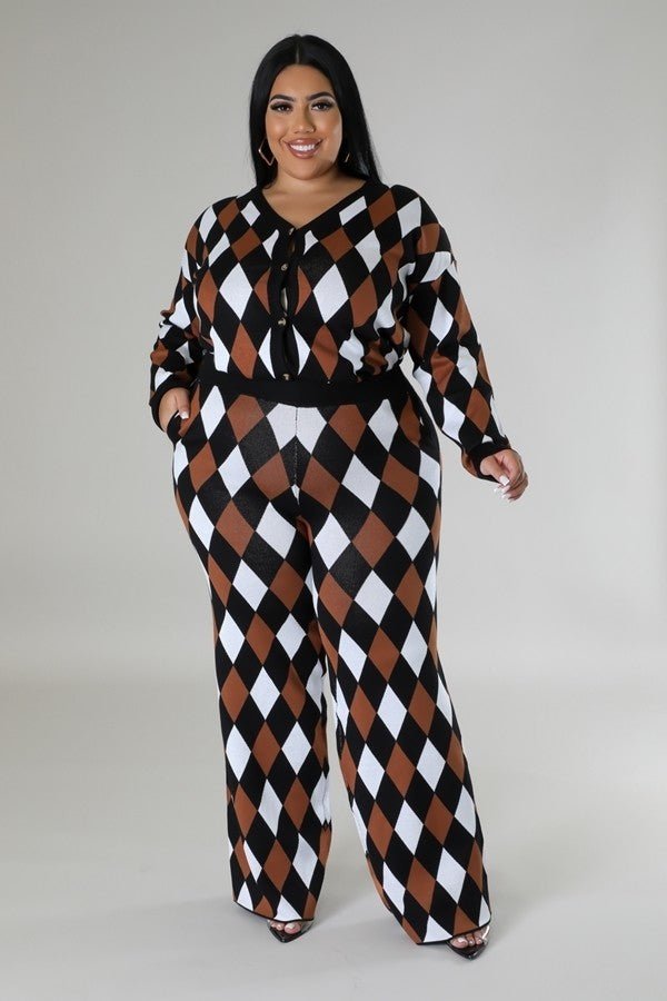 Woman wearing a geometric black, brown, and white two-piece pant set with a button closure and high-waisted pants.