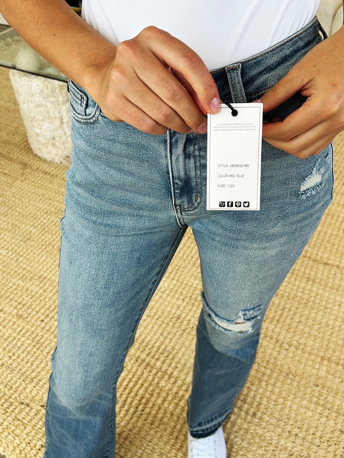 Mid Rise Destroyed Hem Distressed Jeans with tag, moderate stretch, 94% cotton blend, shown on a model.
