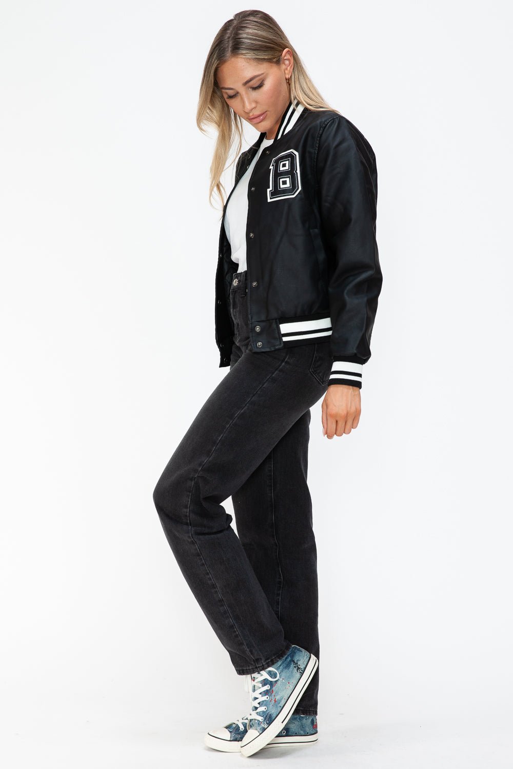 Woman wearing a Midnight Black PU Leather Contrast Snap Down Bomber Jacket with casual jeans and sneakers.