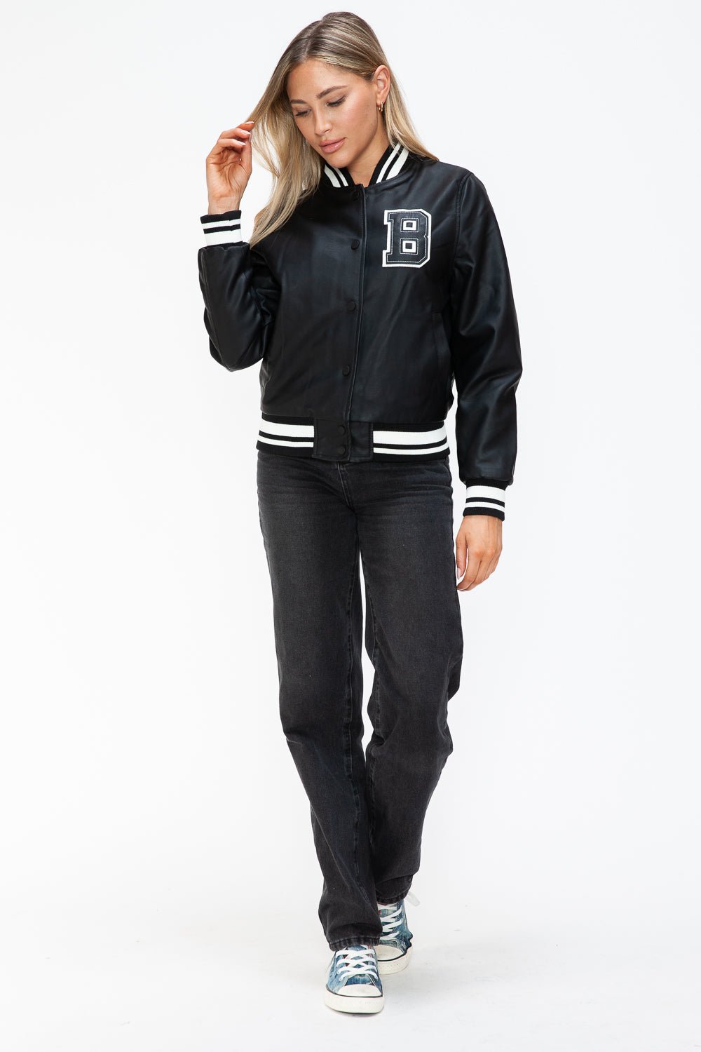 Woman in Midnight Black PU Leather Bomber Jacket with Contrast Snap Down, walking confidently in casual attire.