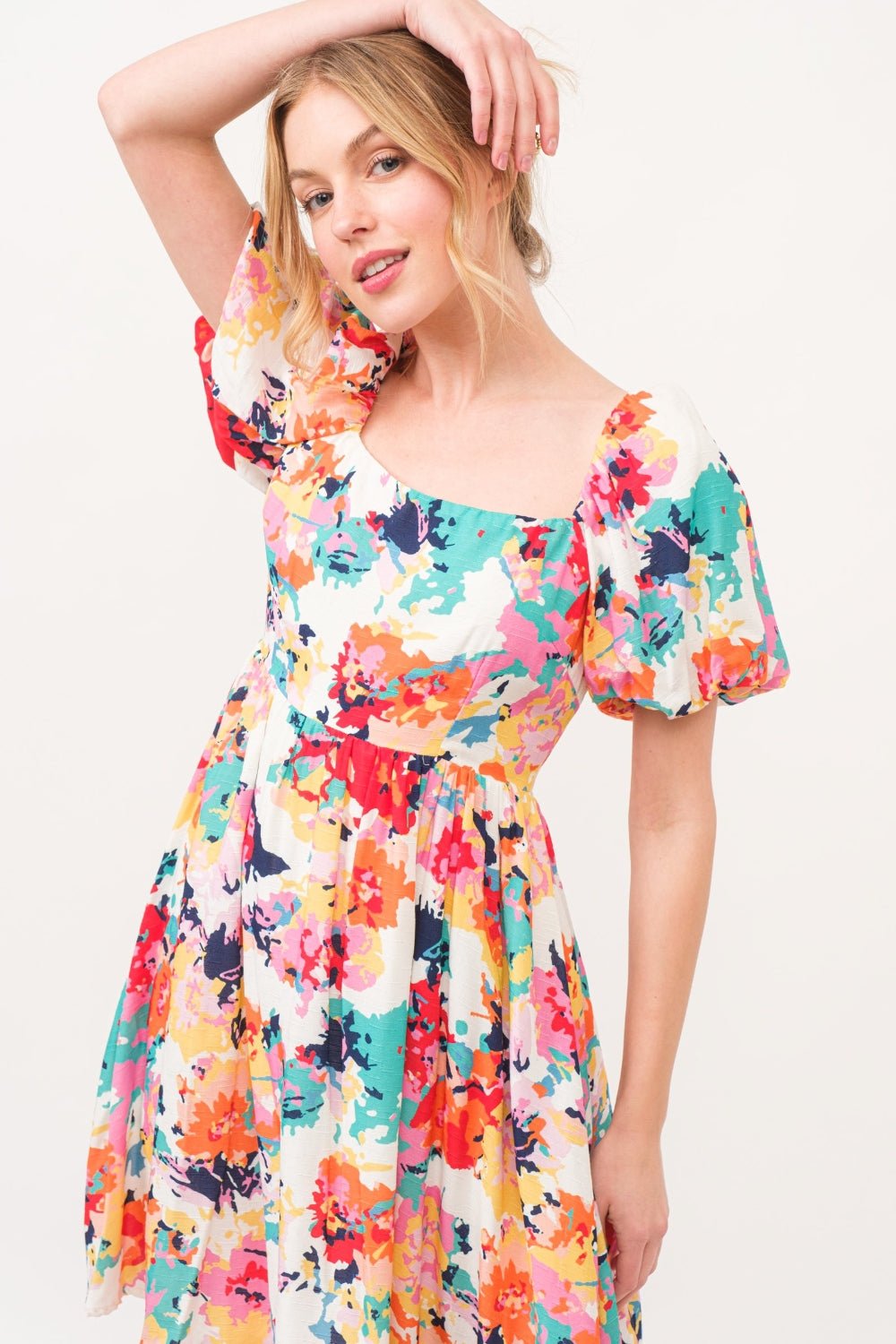 Multicolor square neck puff sleeve floral dress, ruched with pockets, made of 100% polyester, showcasing vibrant floral design.