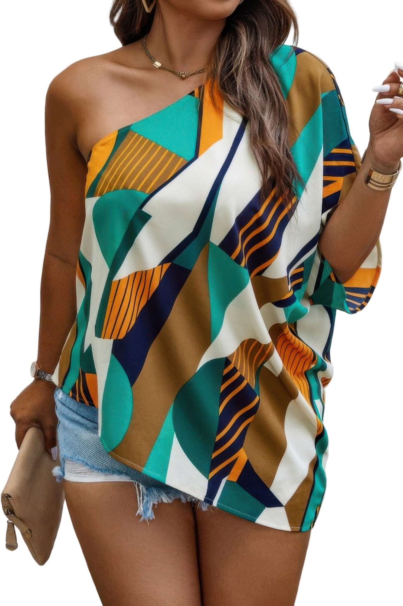 Woman wearing colorful geometric patterned off-shoulder top with teal, orange, navy and white designs, paired with denim shorts. She has layered ne...