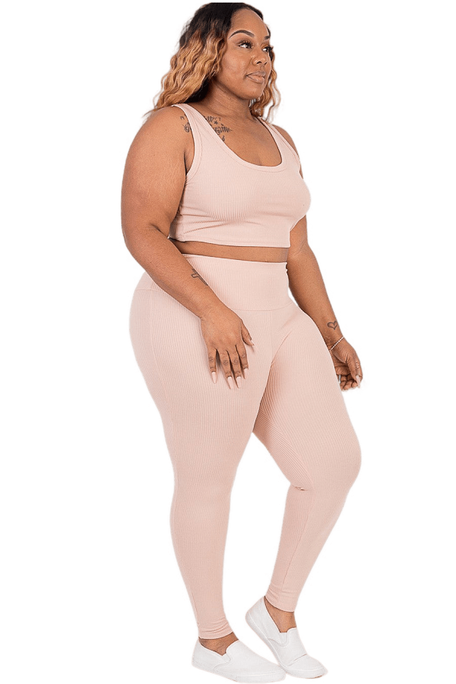 Plus size ribbed crop top and leggings set in pink, highlighting curves and providing comfort for lounge, sports, or party wear.