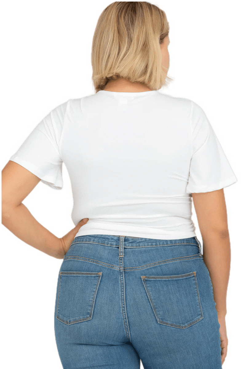 Plus size crop top with strap and short sleeves in soft jersey fabric, back view of model wearing white top and denim jeans.