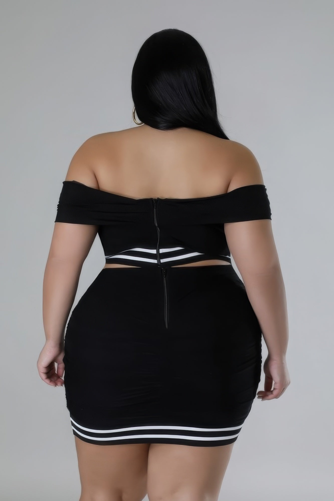 Plus size off-the-shoulder stretch skirt set in black with zipper closure and elastic waistband, shown from the back.