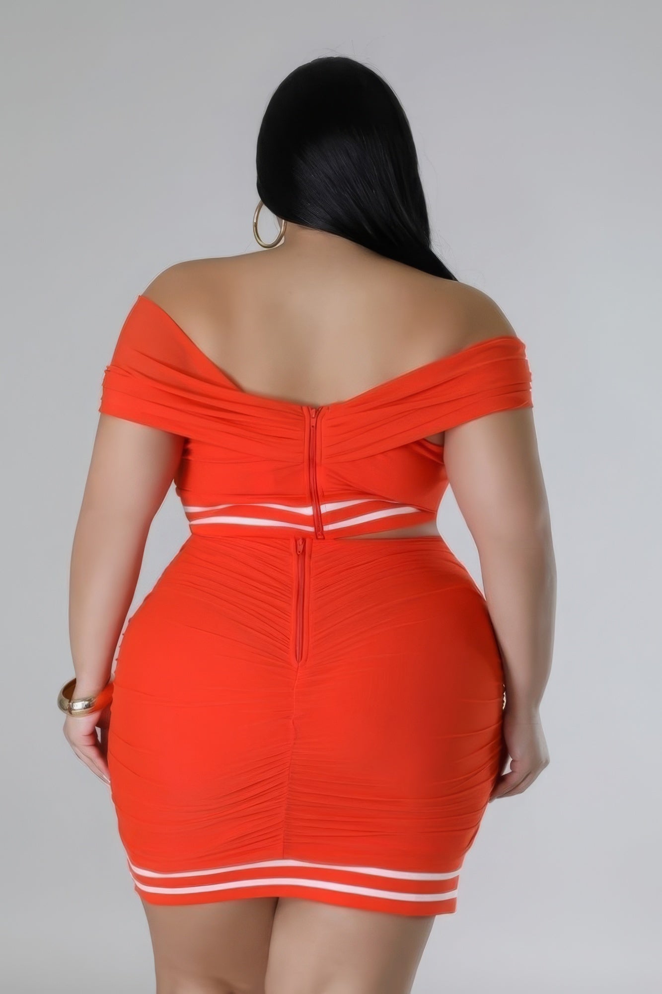 Plus size orange stretch skirt set with off-the-shoulder design and sweetheart neckline, featuring mesh accents and high-waisted skirt.