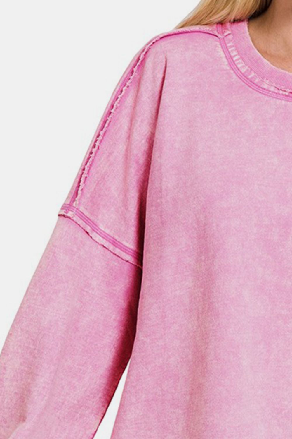 Pink round neck dropped shoulder sweatshirt with exposed seam in soft cotton fabric, showcasing moderate stretch and opaque finish.