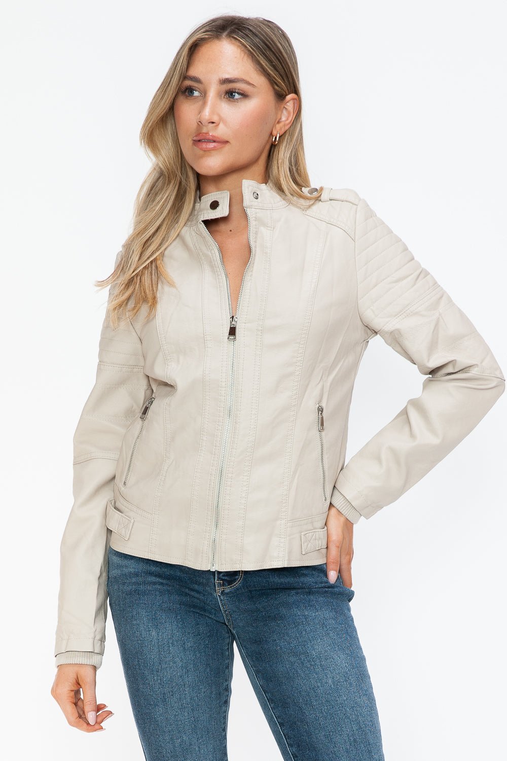 Woman wearing sand PU leather biker jacket with side zip pockets and basic style, not lined, made of 100% pleather.