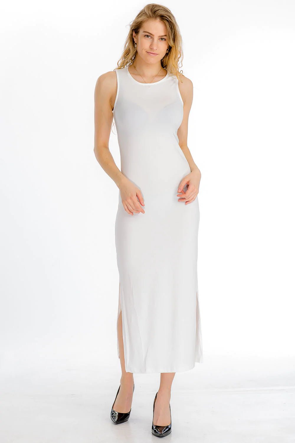 Woman wearing a white side split tank maxi dress with sleeveless, round neckline, and form-fitting silhouette.