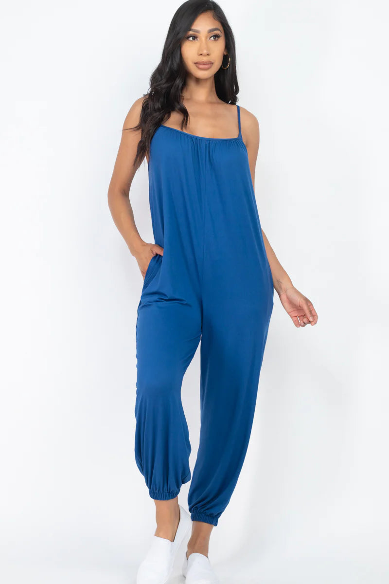 Blue sleeveless jogger jumpsuit with spaghetti straps, soft lightweight fabric, and high stretch. Perfect for casual wear.