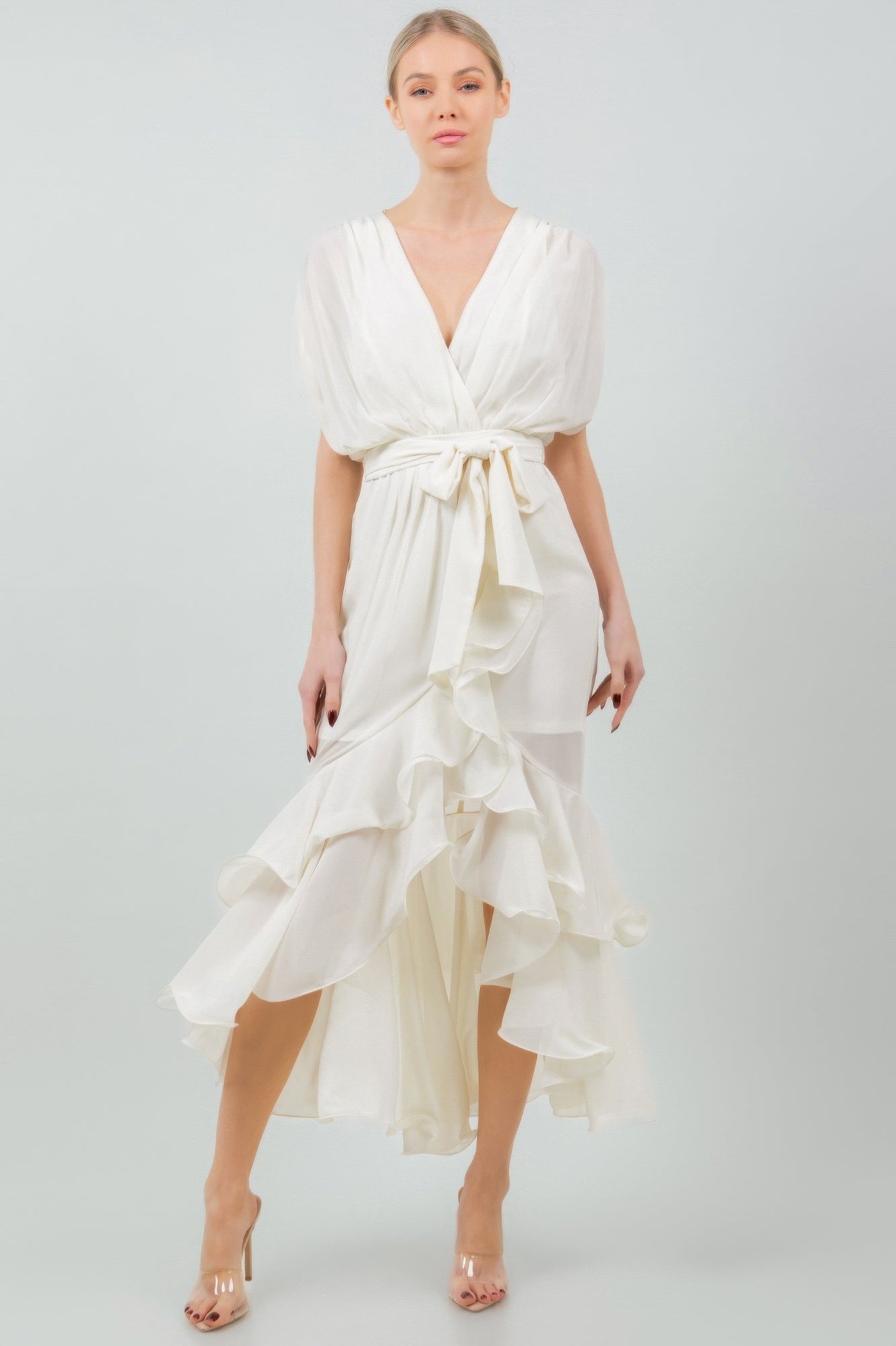 Elegant white ruffle midi dress with tie waist, featuring soft fabric and cascading layers, perfect for stylish occasions.