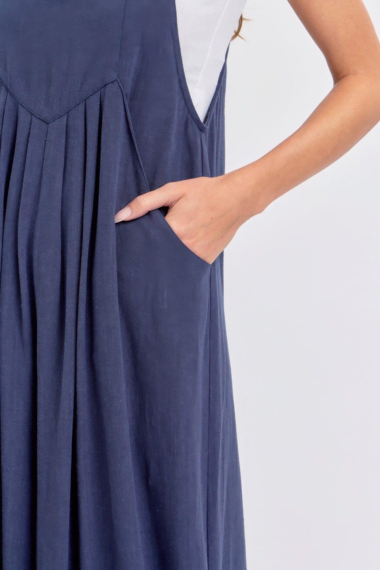 "Navy adjustable strap jumpsuit with wide legs and pocket detail, featuring a comfy rayon-linen blend for a chic and relaxed look"