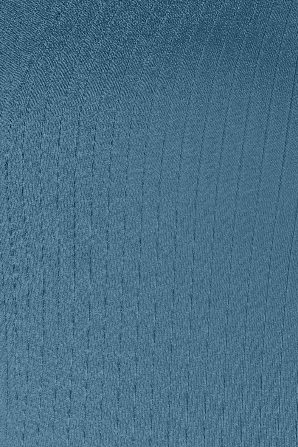 Close-up of blue ribbed fabric texture with vertical lines.