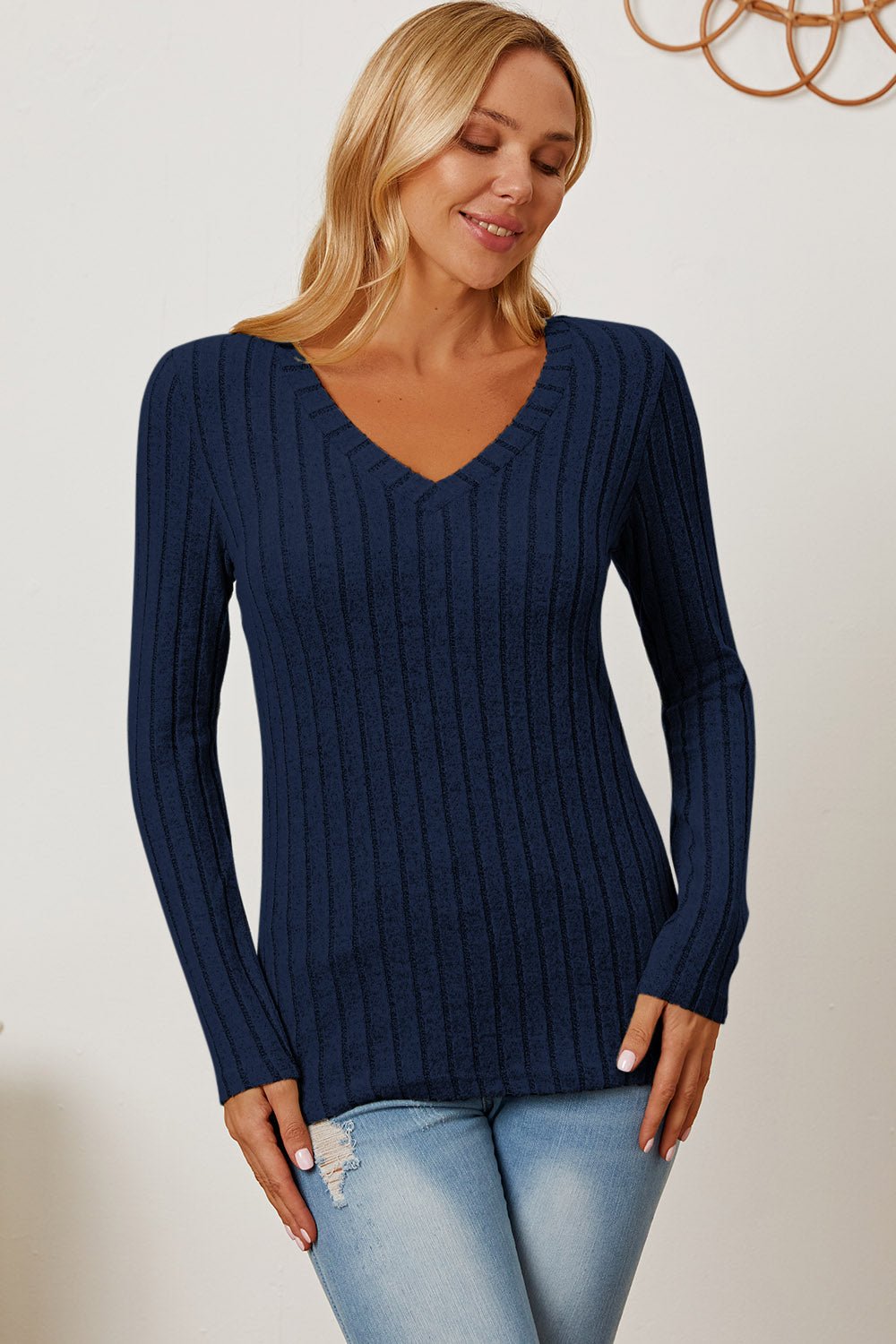 Woman wearing Basic Bae full-size ribbed V-neck long sleeve T-shirt in navy blue with slight stretch and comfortable fit.