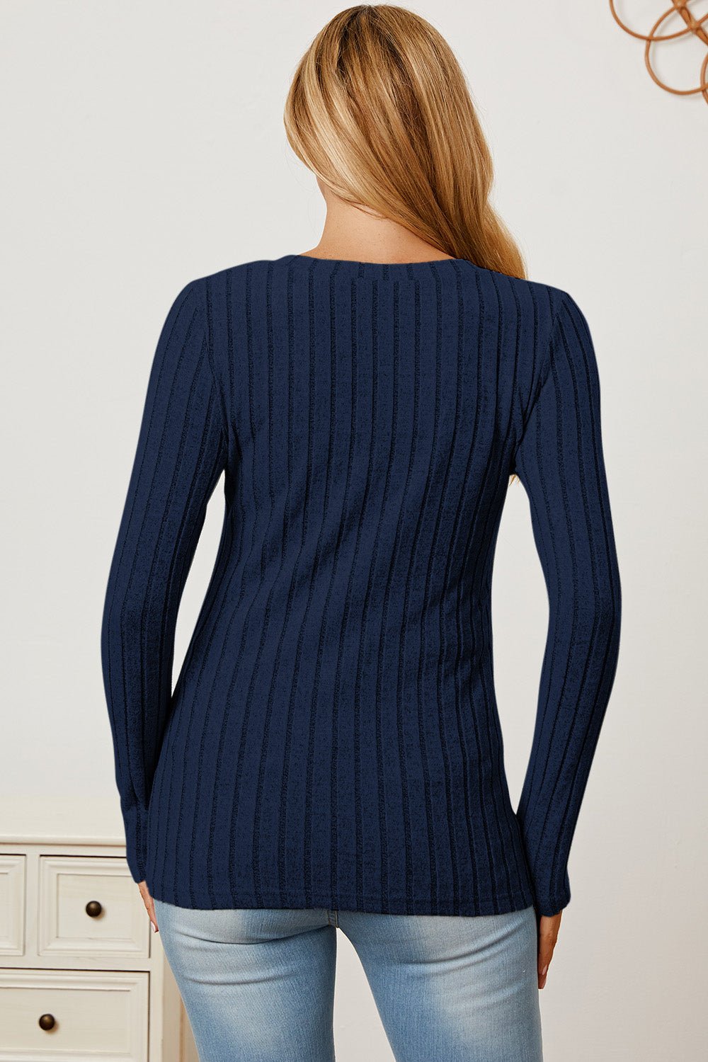 Blue ribbed V-neck long sleeve t-shirt, back view, paired with jeans. Basic Bae style, slightly stretchy fabric, modern casual look.